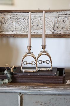 two candles sitting on top of a wooden table