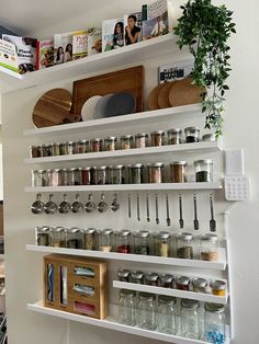 the shelves are filled with spices and jars