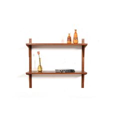 two wooden shelves with vases and books on them