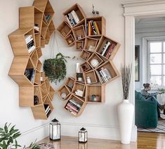 a living room with bookshelves on the wall and a potted plant in the corner