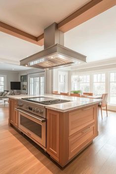 a kitchen with an oven, stove and dining room table in the backround