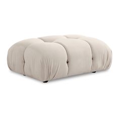 a white ottoman with four pillows on it