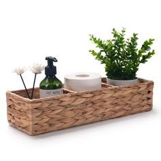 a wooden basket with soap, lotion and plants in it on a white background