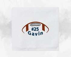 a white towel with the words 25 gavin on it and an orange football ball