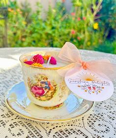 a tea cup filled with candy sitting on top of a saucer