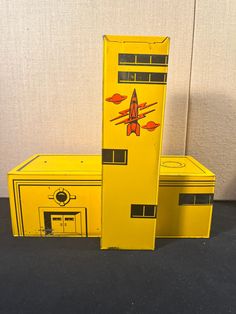 three yellow boxes are stacked on top of each other