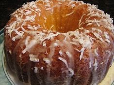 a bundt cake with white icing and coconut sprinkles