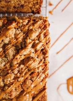 a close up of a piece of cake with icing on it and some caramel drizzle