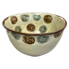 a white and brown bowl sitting on top of a table