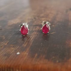 🤍TEARDROP RUBY STUDS  These teardrop ruby earrings feature stunning ruby earrings which are genuine, natural gemstones.  The faceted 6x4mm teardrop rubies are prong set in sterling silver earring studs. The classic pink ruby gems in silver settings makes for a lush and stylish pair of earrings.  The colour of these rubies is a beautiful bright pink ruby colour. The silver and red is a striking colour combination. These earrings are feminine and pretty. These rubies are pear cut, faceted, natural gemstones. They have had some glass fill treatment. Each ruby has a diameter of 4mm and a height of 6mm.  The earrings settings and posts are sterling silver. The earrings are supplied with sterling silver butterfly backs as shown in the image. 🤍 PACKAGING I take great pride in making my jeweller Pear-shaped Ruby Gemstone Earrings, Pear-shaped Ruby Earrings, Pear-shaped Ruby Earrings For Gift, Ruby Stud Earrings, Ruby Earrings Studs, Pink Ruby, Birthstone Earrings, Earring Studs, Ruby Earrings