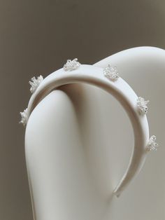 a close up of a white ring on a mannequin