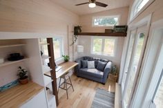 a small living room with wood floors and white walls