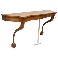 a wooden desk with metal legs and a curved top