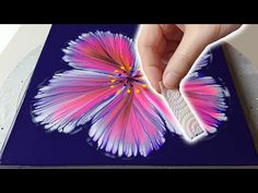 a person is painting a flower with acrylic paint