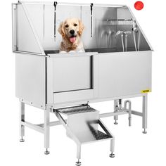 a dog sitting in the back of a stainless steel sink