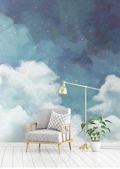 a room with a chair, lamp and clouds painted on the wall