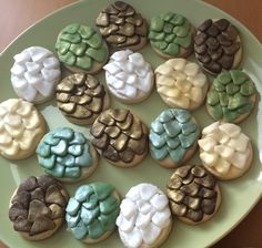 a green plate topped with cookies covered in frosting