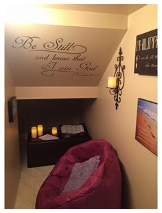 a small room with a bean bag chair and candles on the wall next to it