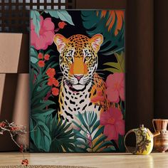 a painting of a tiger surrounded by tropical plants and flowers on a wooden table next to a potted plant