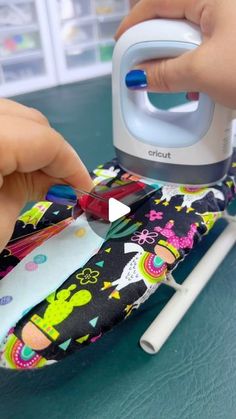 someone is using an iron to sew fabric