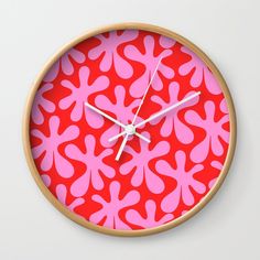 a clock with pink and red designs on it