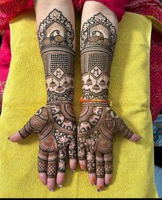 two hands with henna tattoos on them