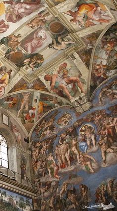 the ceiling is painted with many different paintings