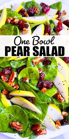 a white plate topped with spinach and pear salad next to a bowl of cranberries