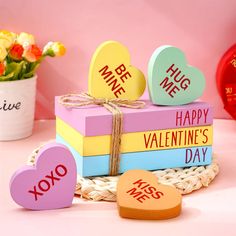 valentine's day gifts are stacked on top of each other with hearts attached to them