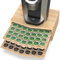 a stack of coffee cups sitting on top of a wooden tray next to an espresso machine