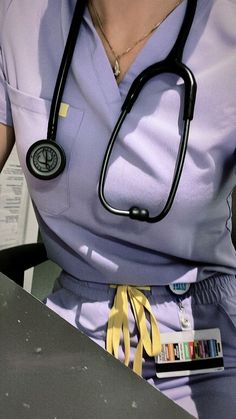 a woman with a stethoscope sitting at a table