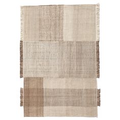 an area rug with multiple squares and fringes on the bottom, in neutral colors