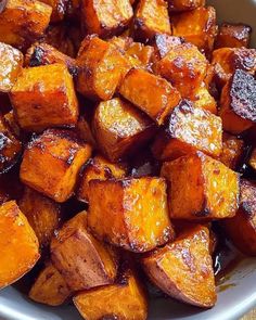 a white bowl filled with cooked sweet potatoes