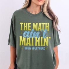 a woman wearing a t - shirt that says the math isn't mahin show your work