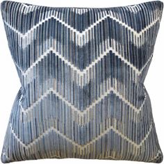 a blue and white pillow with an abstract design on the front, featuring wavy lines