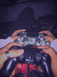 two people holding video game controllers in their hands