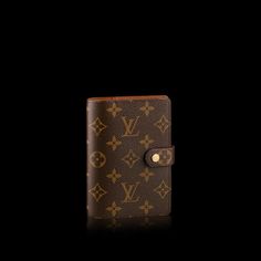 a brown louis vuitton wallet on a black background