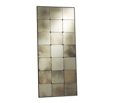 a mirror that is sitting on top of a white wall and has squares in it