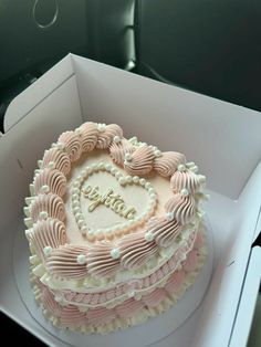 a heart shaped cake in a white box