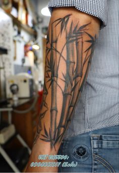 a man with a bamboo tattoo on his arm