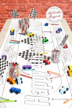 a white table topped with lots of toys on top of a checkered table cloth