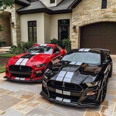 two sports cars parked in front of a house