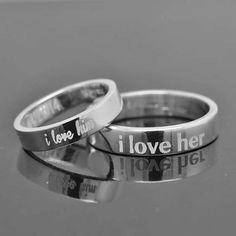 two wedding rings with the words i love you and i love her written on them