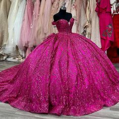 a pink ball gown is on display in a store