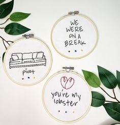 three embroidered hoop art pieces with words on them