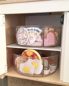 two plastic baskets filled with food on top of a wooden shelf