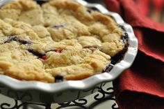 a pie sitting on top of a table next to a red napkin