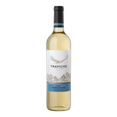 a bottle of white wine with a bird on the label and mountains in the background