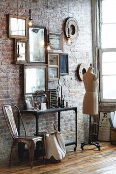 an old fashion shop with mannequins and vintage frames on the brick wall