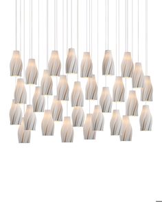 a group of white and beige lights hanging from a long ceiling fixture with one light on each side